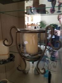 Urn style glas and wrought iron candle holder with river stones.