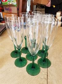 Set of green stemmed champagne glasses