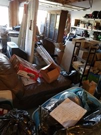 Garage full of items in bins, and boxes and on shelves.