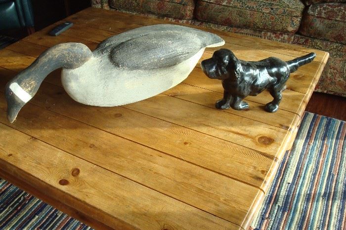 Hand made goose decoy and cast iron dog.