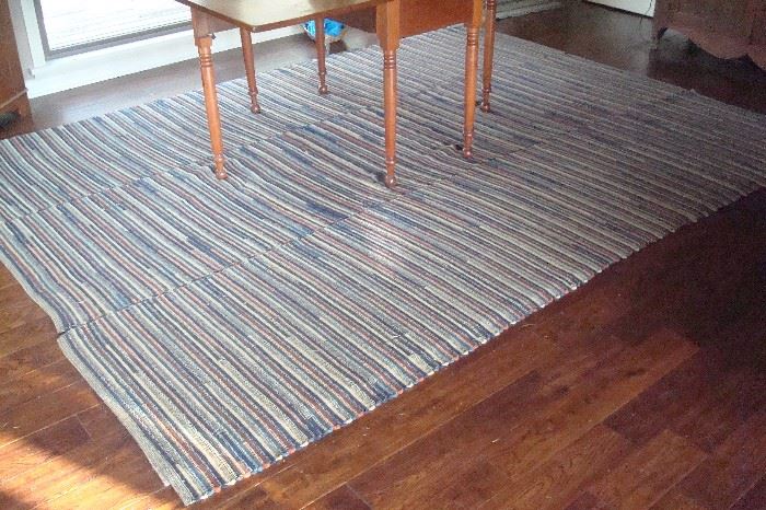 One of two large hand made braided rugs.