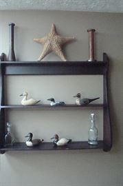Wall rack with antique duck decoys signed BBD.