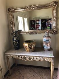 vintage gold leaf mirrors, wood table with marble top,  oriental vases