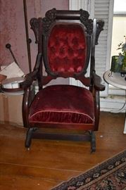Highly Carved Antique Platform Rocker featuring "tufted" Red Velvet Back with Padded Seat