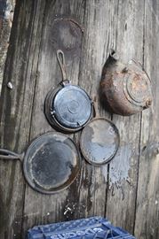 Some of the Antique Iron Cookware found in "discovery" shown here is an Iron Waffle Maker, Pancake Skillets, and Teapot