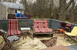 Patio deck furniture including 2 chairs, 1 single chaise lounge, 1 double chaise lounge, marble-top wrought iron table, outdoor rugs