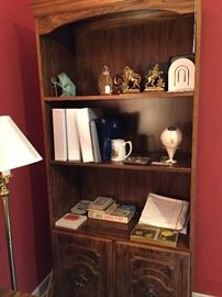 ONE OF A PAIR OF BOOKCASES W/A COLLECTION OF BOOKENDS AND GAMES