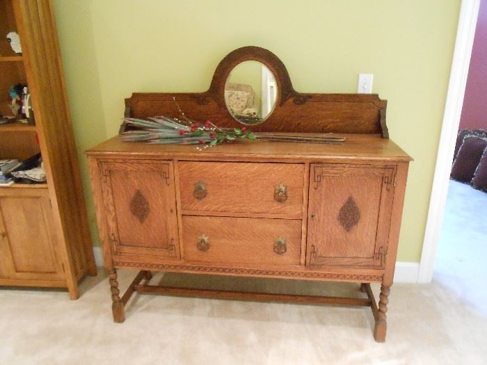 This is beautiful!  The back-splash with arched mirror has ornate carvings around it.  Original pulls