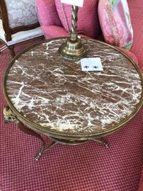 One of two antique marble and brass two tiered tables 27"h x 27.5" in diameter.  Originally $8500 for the pair asking $2400.