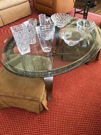 Oval glass and iron based coffee table measures 49.5"l x 37.5"w x 20"h asking $240 Vases and dishes from Simon Pearce and others  Ottomans also for sale as is the carpet