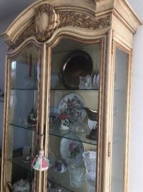 French provincial lighted China display cabinet with glass doors and cabinet below.