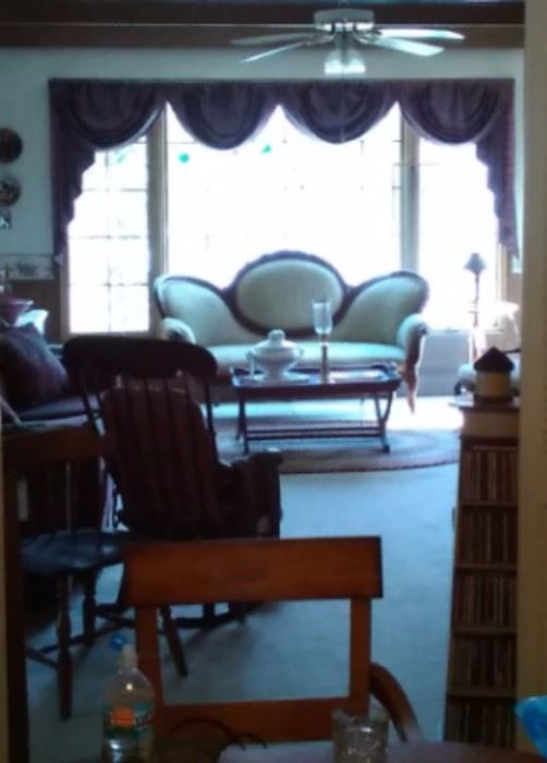 View of TV room with antique and newer furniture, stereo equipment, tables and more 