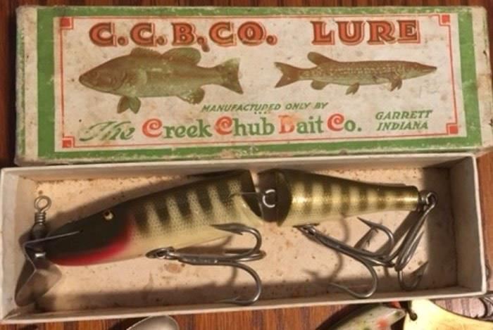 One of twenty vintage lures, most not in boxes. tackle boxes, two fishing poles and four reels