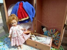 Lovely doll with travel case and clothes.