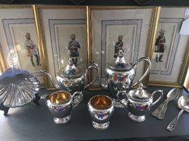 Sterling Shell Dish, 5 Piece Sterling Coffee/Tea Service, Sterling Berry Spoon, and Coin Silver Spoons in front of a Set of 4 Figural Watercolors.