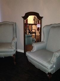 Matching upholstered wingback chairs; tall wall mirror