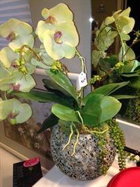 Artificial orchids in unique vase