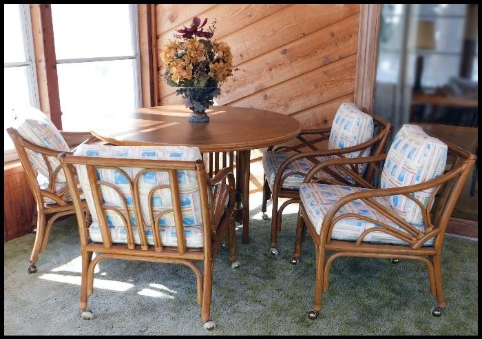  Four Rattan chairs with 4 foot diameter table with two 16 inch leafs
