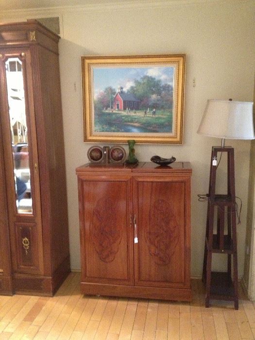 Beautiful fold out bar with fancy carving. Unknown artist large sofa painting.