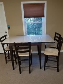 Glass top extendable table with counter top stools