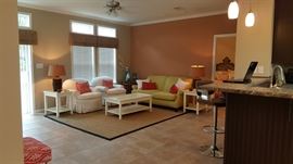 Huntington House Clubs Chairs with down cushions, Martha Stewart seagrass carpet, Apple Green Sofa (sold), off-white end tables and matching coffee table, wicker lamps, round corner rattan table with glass top, glass marine blue vases.