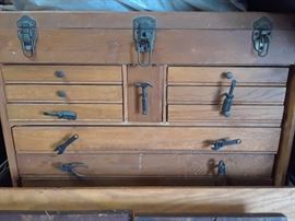 Note the whimsical drawer pulls on this great wood tool cabinet