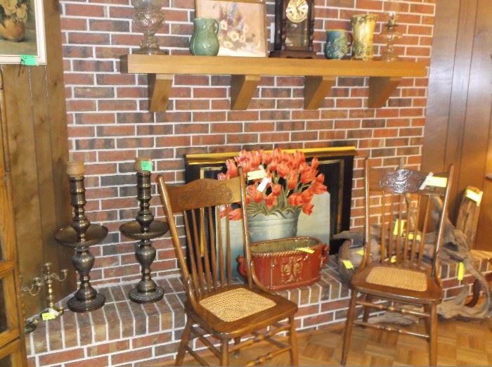 Cane seat chairs, huge brass candlesticks, fire screen, and large red planter