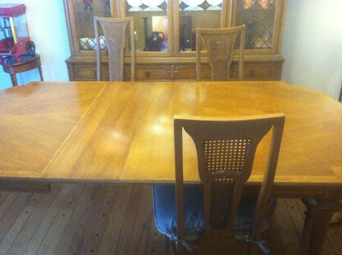 DINING ROOM TABLE HAS ALWAYS BEEN COVERED HAS 2 LEAVES IN IT AND ANOTHER ONE THAT CAN BE PUT IN IT 