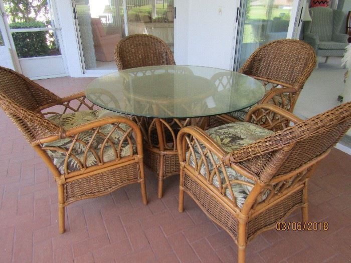 GORGEOUS OUT/INDOOR DINING SET.. 4 RATTAN CHAIRS, RATTAN BASE, GLASS TOP ROUND, CUSHIONS FOR BACK AND SEAT.. ALL TOGETHER THERE ARE 14 PCS.. 