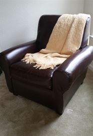 one of pair of leather chairs in den