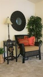 black wicker chair and cushion, small square table, lamp, round leather mirror and silk tree - upstairs hall 