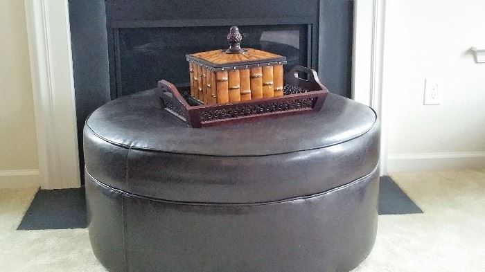 round leather ottoman and decorative box