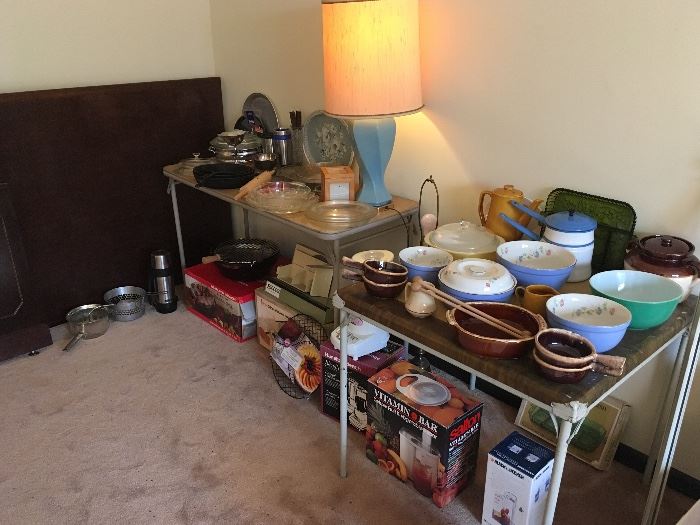 Pyrex bowls, lamps, large executive style conference table(resting against wall), cookware, small kitchen appliances