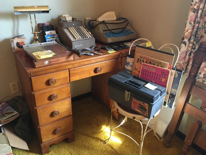 art supplies and book, electric typewriter, wooden desk, ice cream parlor style chair, lamps