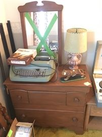 electric typewriter, vintage lamp, small wooden dresser