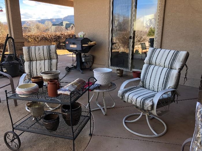 Assorted patio furniture and smoker.  We also have another wrought iron table and 4 chairs not yet pictured 