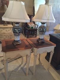 Two porcelain lamps with silk shades.