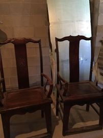 Two antique wood arm chairs. Sold as a pair.