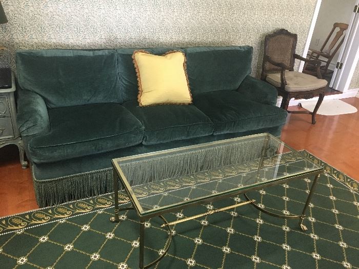 Green velvet sofa, gold table & rug