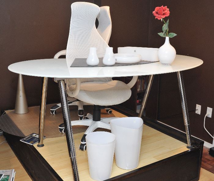 White glass desk, two white desk chairs and accessories