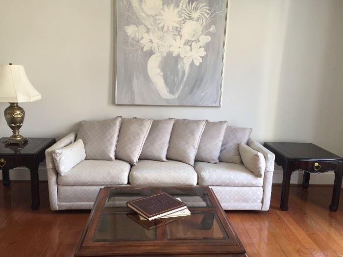 Sofa, artwork, coffee table and end tables.