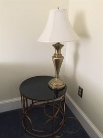 Brass lamp and round table.