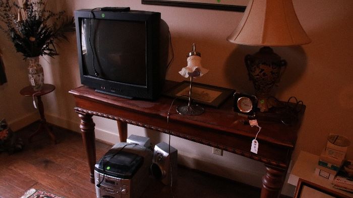 Various sizes of TVs throughout home, CD player