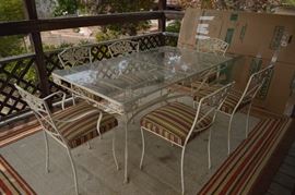 Wrought iron table and chairs with glass top
