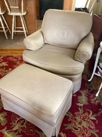 Upholstered armchair with ottoman