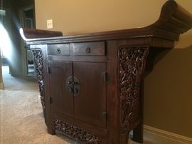 Ornate arms on Chinese antique altar piece 