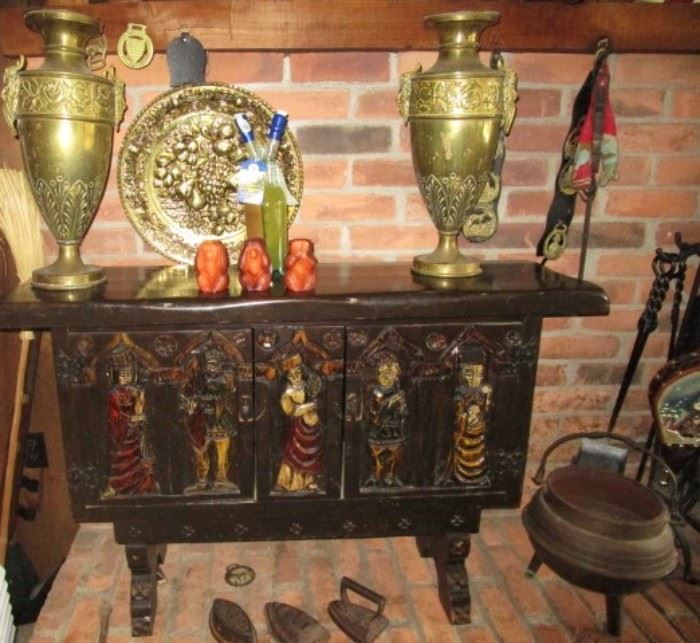 Carved cupboard, sad irons, brass vases, misc.