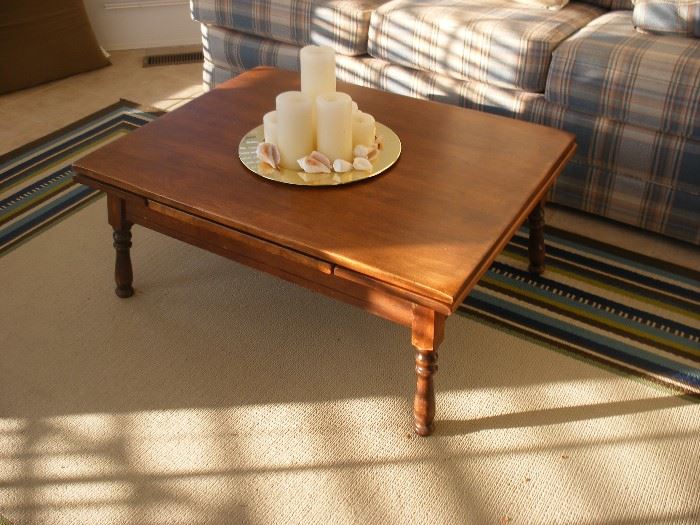 Hard Rock maple coffee table has two pull out leaves.