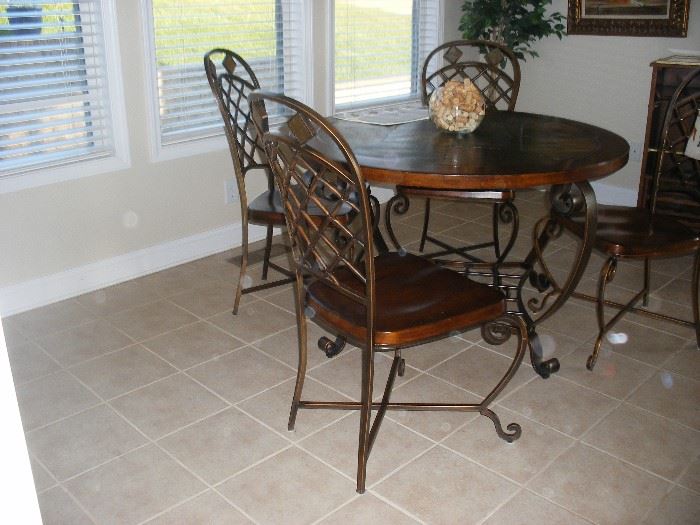 Kitchen table has tile top with wood trim.  4 chairs.