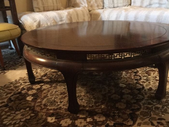 Round coffee table with Asian inspired accents